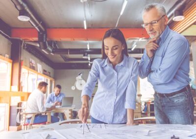Designers working with drafting equipment and blue prints